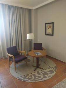 a living room filled with furniture and a lamp at Parador de Lorca in Lorca
