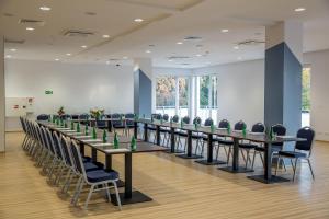 a large conference room with long tables and chairs at Mielno Holiday Apartments in Mielno +24 photos