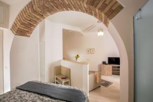 a bedroom with an archway and a bed in a room at Vatican Studio Apartment in Rome