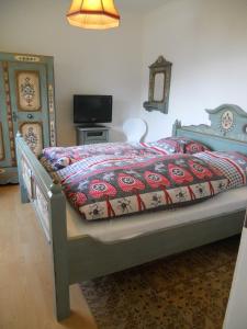 バードガシュタインにあるWohnung Enzianのベッドルーム1室(ベッド1台、掛け布団、テレビ付)