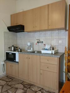 a kitchen with wooden cabinets and a sink at Agni in Nafpaktos
