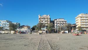 an empty beach with tall buildings in the background at AmbientHotels Panoramic in Rimini