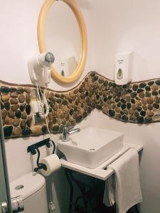 a bathroom with a sink and a mirror at Austeria in Ostróda