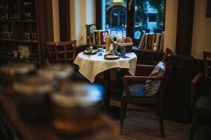 a table with a white table cloth on it at Szekszárd Szálló in Szekszárd