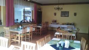 a restaurant with tables and chairs and a dining room at Gasthaus Schwarzer Adler in Altenberg