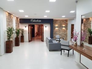 a lobby with a couch and chairs in a building at Hotel Prime Executive in Campos Novos