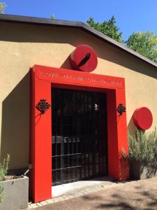 a red entrance to a building with a red door at I sogni nel Cassetto Airport BLQ in Bologna