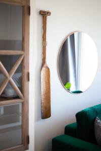 a mirror and a wooden bat hanging on a wall at Baltic Apartments Seaside Towers in Gdańsk