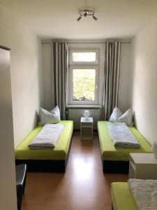 a room with two beds and a window at Süd-Apartments in Leipzig