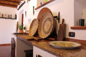 a kitchen with a counter with a pizza on it at Agriturismo Cuile de Molino in Porto Torres