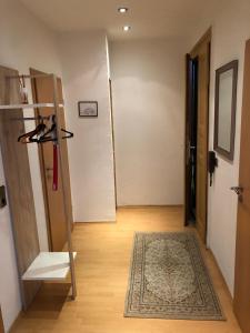 a hallway with a door and a shelf and a rug at Süd-Apartments in Leipzig