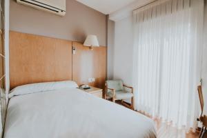 Postel nebo postele na pokoji v ubytování Hotel Isasa