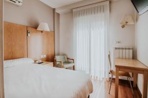 Postel nebo postele na pokoji v ubytování Hotel Isasa