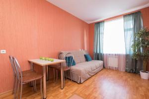 a living room with a couch and a table at Апартаменты на Тимирязева 35 in Nizhny Novgorod