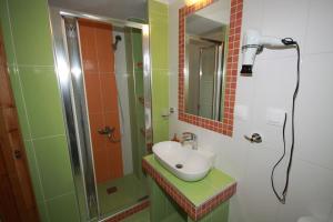 a bathroom with a sink and a shower at ZEPHYROS ROOMS in Ormos Panagias