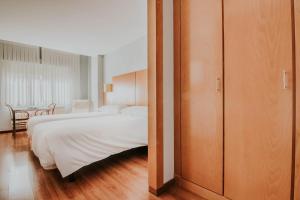 Postel nebo postele na pokoji v ubytování Hotel Isasa