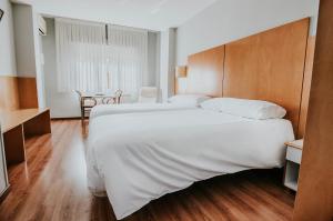 Postel nebo postele na pokoji v ubytování Hotel Isasa