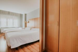 Postel nebo postele na pokoji v ubytování Hotel Isasa