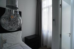 a bedroom with a lamp hanging over a bed at Stylish house - air cond, breakfast, free parking in Vila Nova de Gaia
