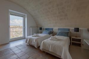 A bed or beds in a room at LAMIA MATERA 11
