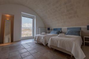 A bed or beds in a room at LAMIA MATERA 11