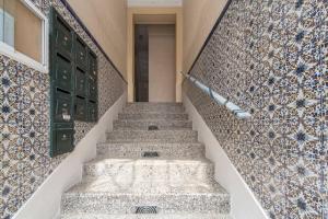 a set of stairs with a door and tiles at Safe House in Lisbon