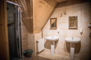 a bathroom with two sinks and a shower at Rezydencja Sąsiadów Zakopanego in Zakopane +57 photos