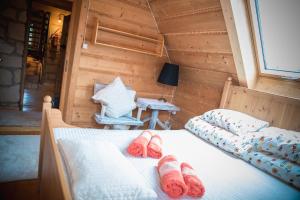 a bedroom with two beds and a table with a lamp at Rezydencja Sąsiadów Zakopanego in Zakopane
