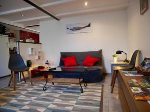 a living room with a couch and a table at Coeur des Domes in Fontfreide