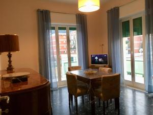 a dining room with a table and chairs and a television at Diamante in Sorrento