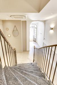 an empty hallway with stairs in a house at Hotel Courseine in Courbevoie