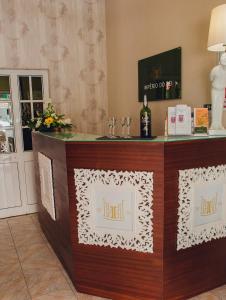 a reception desk in a hotel room with a bottle of wine at Hotel Império do Rei in Castelo Branco