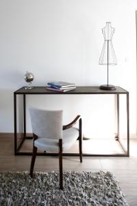 a desk with a chair and a table with a lamp at Auberge Du Paradis in Saint-Amour-Bellevue