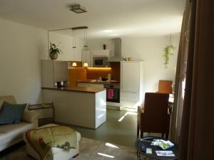 a kitchen and living room with a couch and a table at Oerlihome in Oerlinghausen