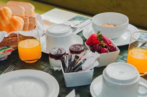 a table with breakfast foods and drinks on it at Império do Rei Boutique Hotel in Castelo Branco +19 photos