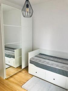 a bedroom with a bed and a mirror at Apt Pawia in Warsaw