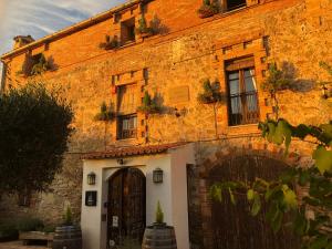 an old brick building with a door and windows at Tur&oacute; de la Torre in Manresa