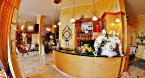 a bar in a restaurant with a clock on the wall at Hotel Italia in Lerici