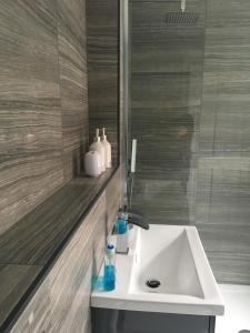 y baño con lavabo blanco y espejo. en Bright Moments Holiday Home, en Beverley