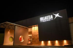 a sign on the side of a building at night at Uiramutam Palace Hotel in Boa Vista