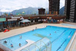 a large swimming pool on top of a building at Au pied des pistes (Le Corbier/73) in Villarembert
