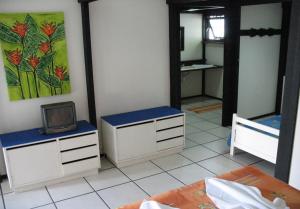 a bedroom with two dressers and a mirror at Pousada Morada Das Toninhas in Ubatuba