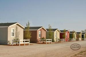 a row of houses on a dirt road at Eagle Ford Village Suites in Dilley