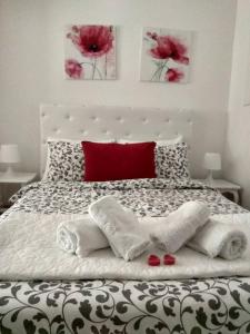 a bedroom with a large bed with red pillows at Gardos in Belgrade