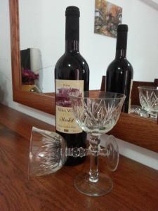 a bottle of wine and a glass on a table at Villa Milev in Kranevo
