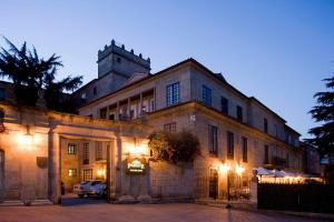 a large building with a clock on the side of it at Parador de Pontevedra in Pontevedra