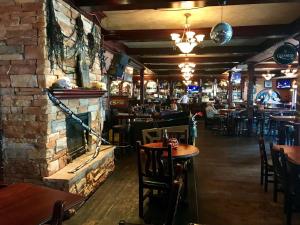 a restaurant with tables and chairs and a brick wall at The Steveston Cafe & Hotel in Richmond