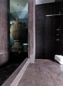 a large vase in a room with a mirror at Demetria Hotel in Guadalajara