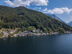 an aerial view of a village on the shore of a lake at Landhotel Grünberg am See in Gmunden