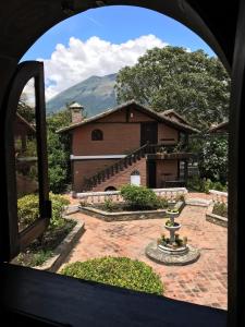 a view of a house from a window at Hotel y Hosteria Natabuela in Natabuela
